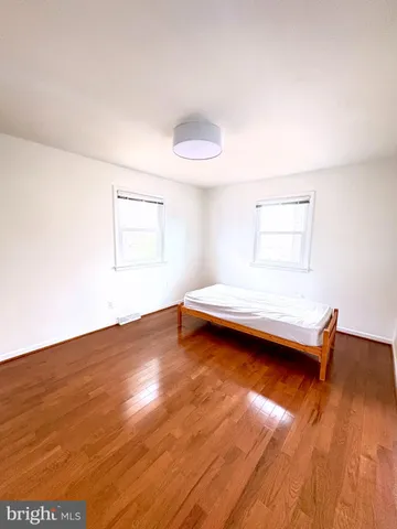 a view of a room with wooden floor and window