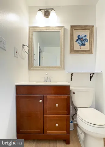 a bathroom with a toilet a sink and mirror