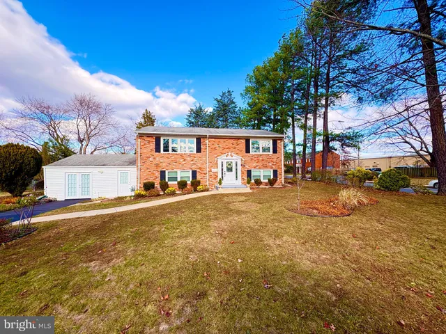 a view of a backyard with table and chairs plants and wooden fence