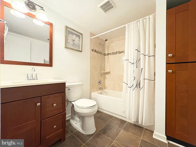 a bathroom with a sink toilet a shower and a mirror