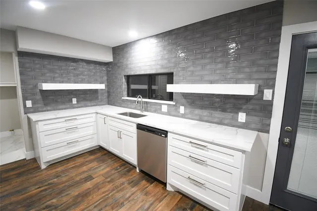 a kitchen with a sink stainless steel appliances and cabinets