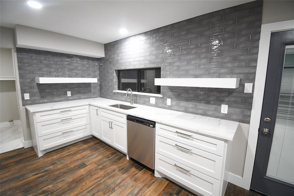 a kitchen with a sink stainless steel appliances and cabinets