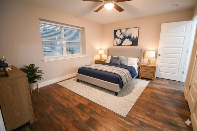 a spacious bedroom with a large bed and a chandelier