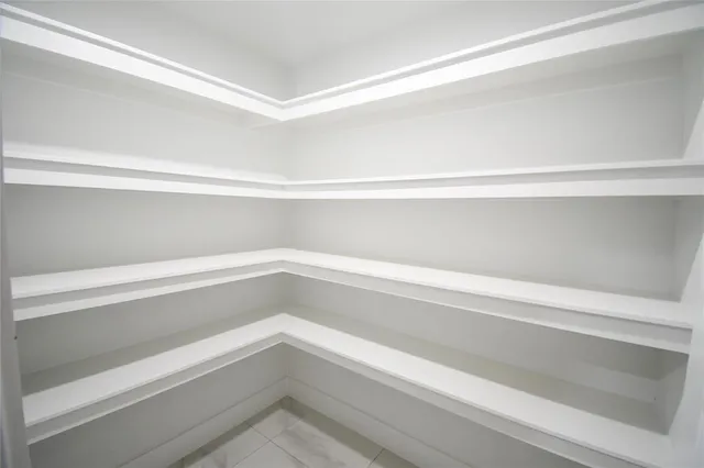 a close view of closet with white walls