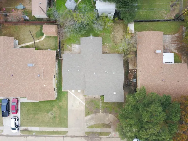 an aerial view of a house with a yard