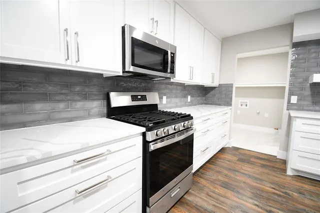 a kitchen with a stove and a microwave