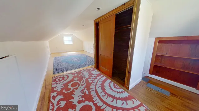 a view of a room with wooden floor and staircase