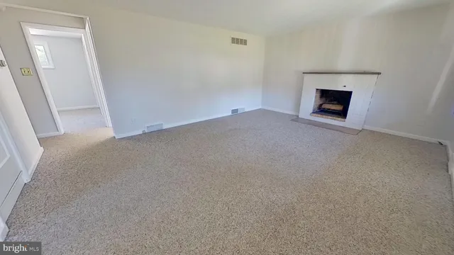 an empty room with a fireplace