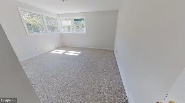 a view of empty room with floor to ceiling window