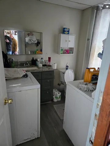 a room with a sink and wooden floor
