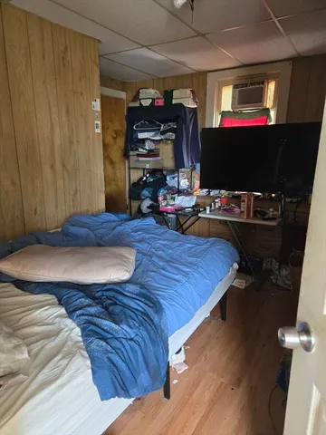 a bedroom with a bed and flat screen tv