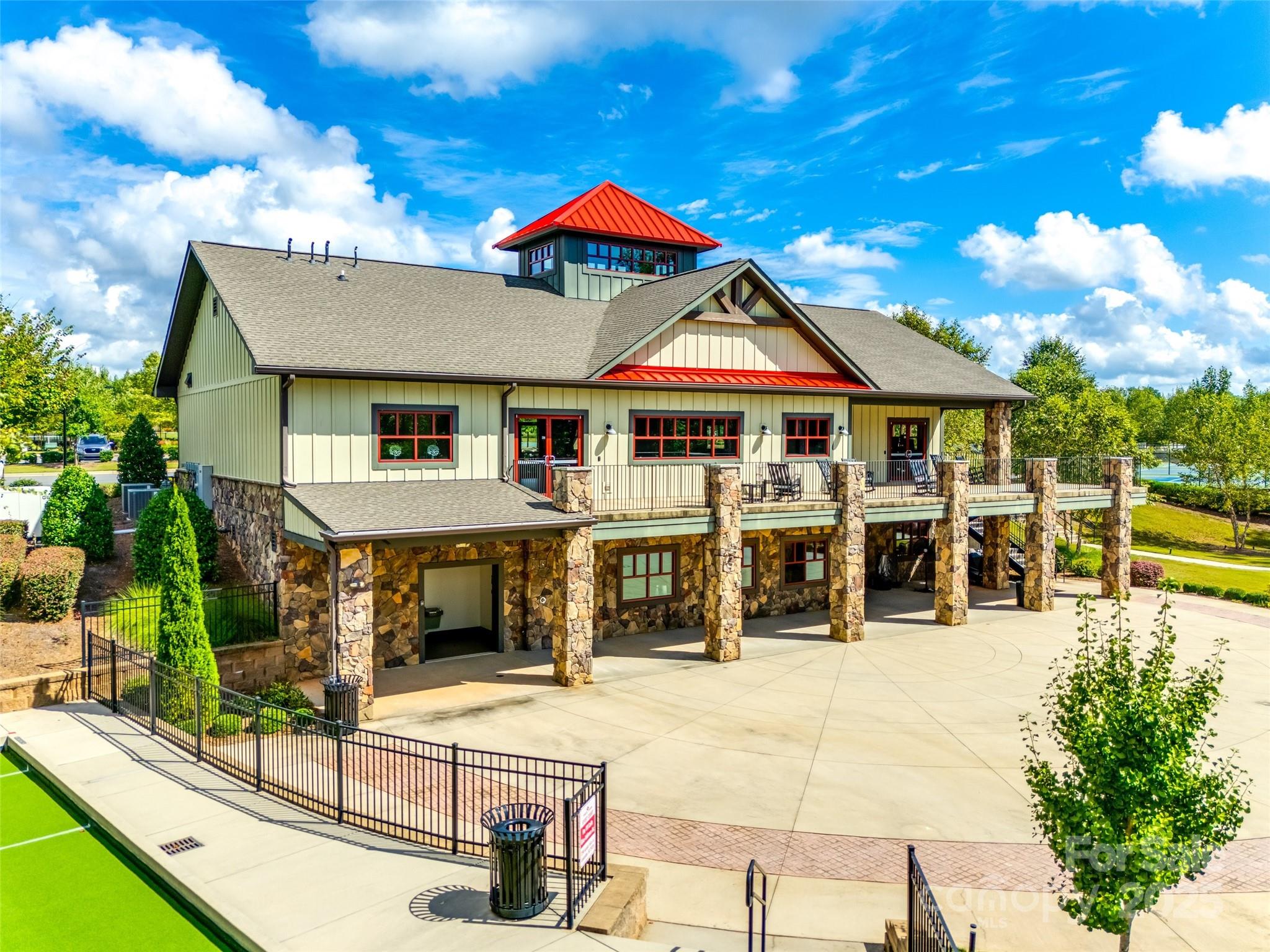 1609 Tranquility Boulevard Lancaster, SC 29720 - Photo 25 of 29 a view of a white house with large windows and a table and chairs