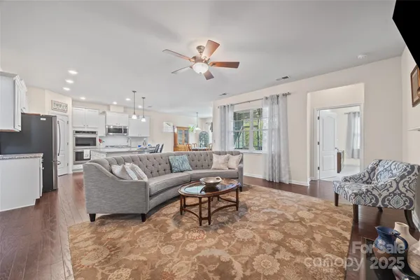a living room with furniture and kitchen view