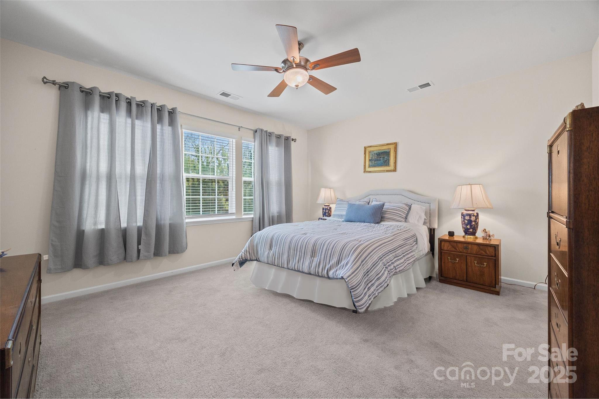 1609 Tranquility Boulevard Lancaster, SC 29720 - Photo 8 of 29 a spacious bedroom with a bed painting and a large window