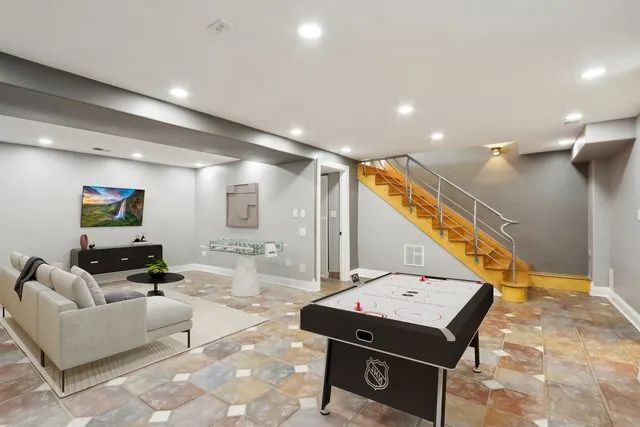 an aerial view of a house with a yard basket ball court and outdoor seating