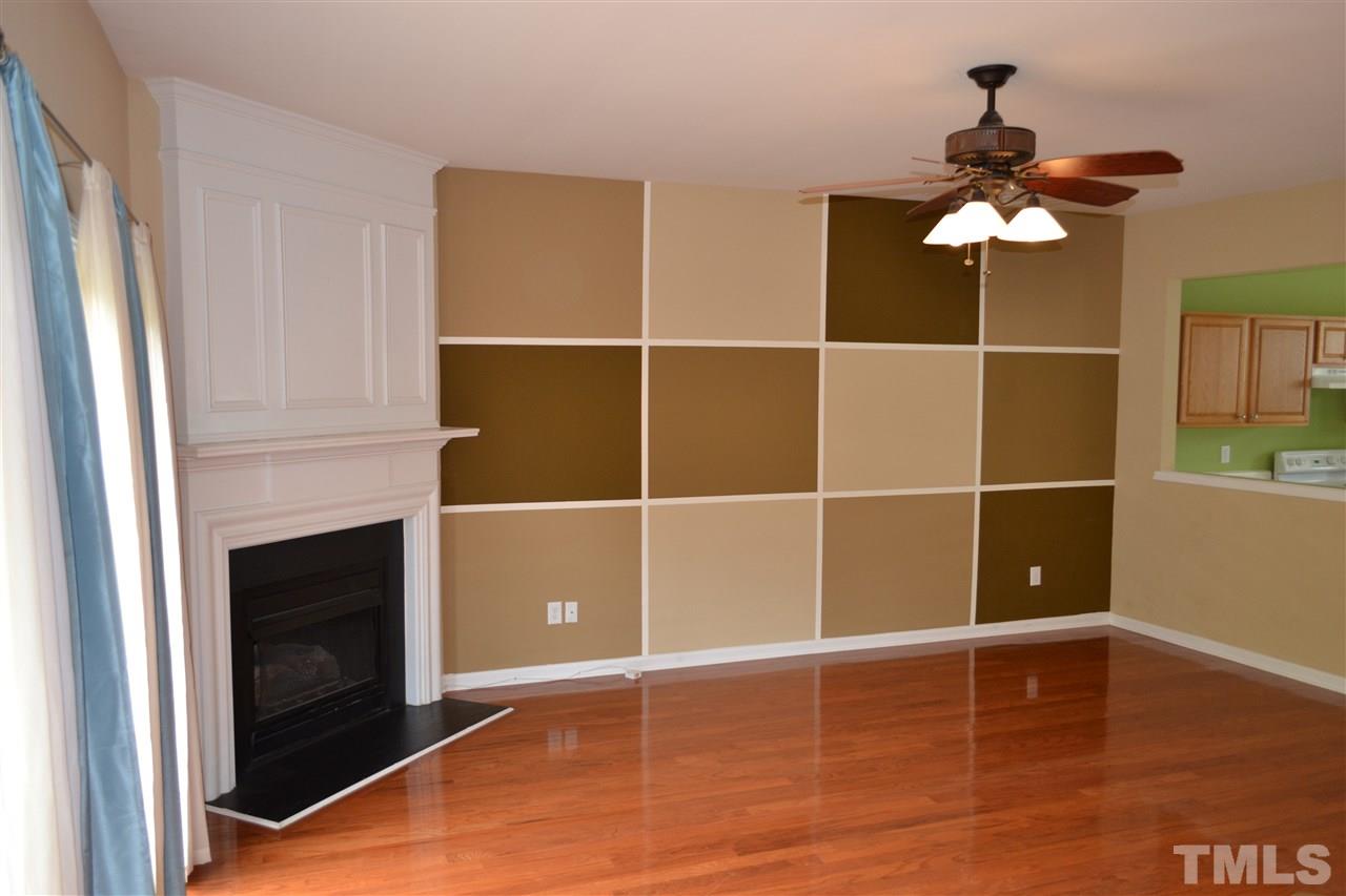 5125 Echo Ridge Road Raleigh, NC 27612 - Photo 3 of 13 a view of a livingroom with hardwood floor and a ceiling fan