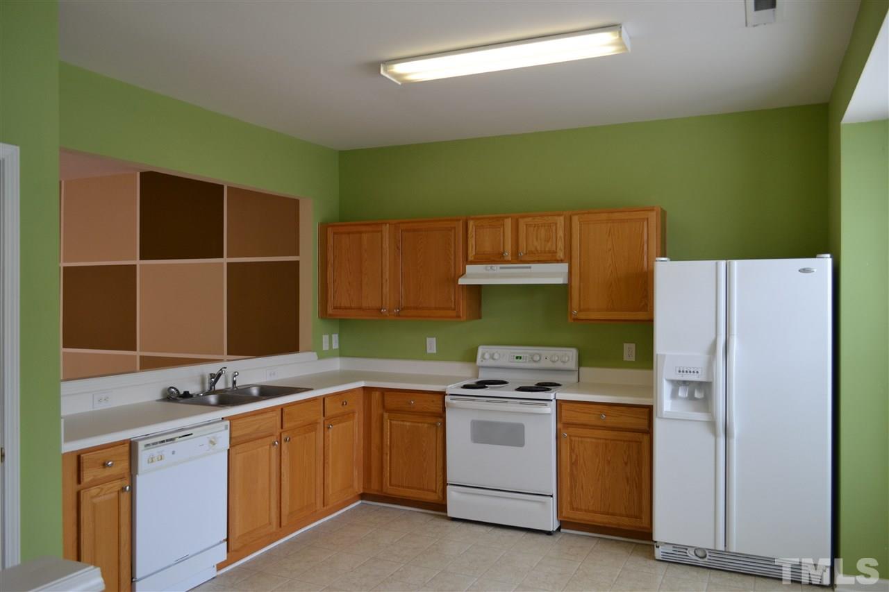 5125 Echo Ridge Road Raleigh, NC 27612 - Photo 5 of 13 a kitchen with a sink and a refrigerator