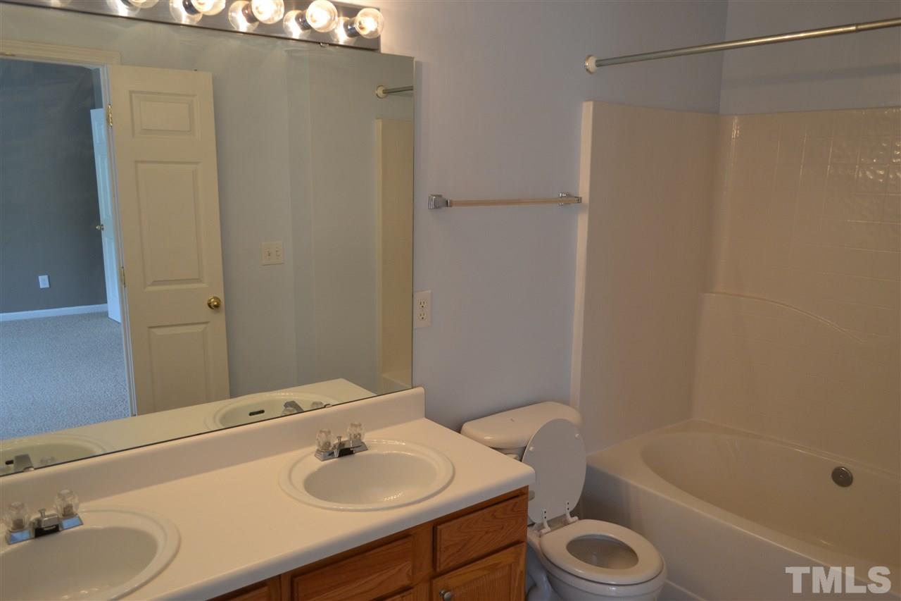5125 Echo Ridge Road Raleigh, NC 27612 - Photo 9 of 13 a bathroom with a sink a toilet and shower