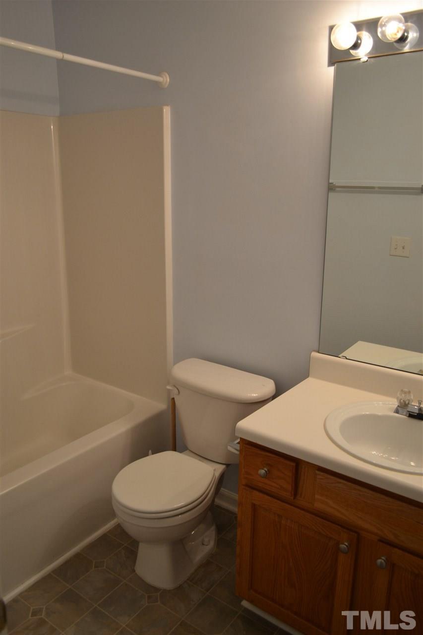 5125 Echo Ridge Road Raleigh, NC 27612 - Photo 10 of 13 a white toilet sitting next to a bath tub