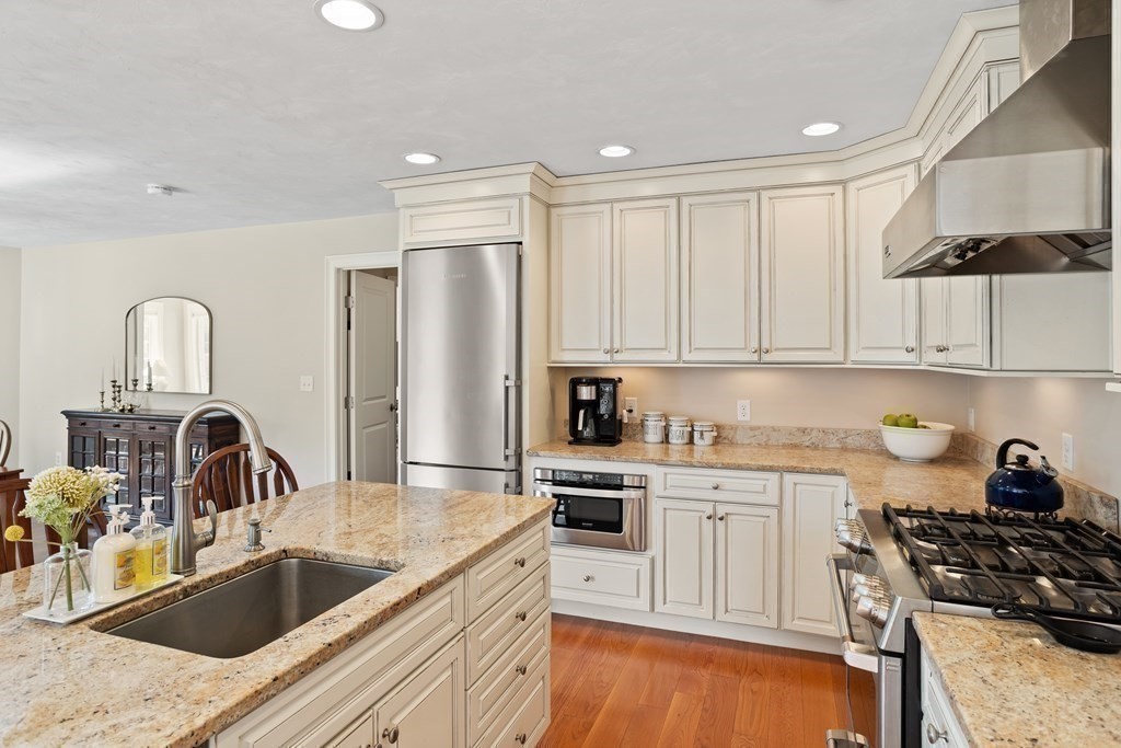 145 Old Farm Way Ayer, MA 01432 - Photo 12 of 39 a kitchen with stainless steel appliances granite countertop a sink stove and refrigerator