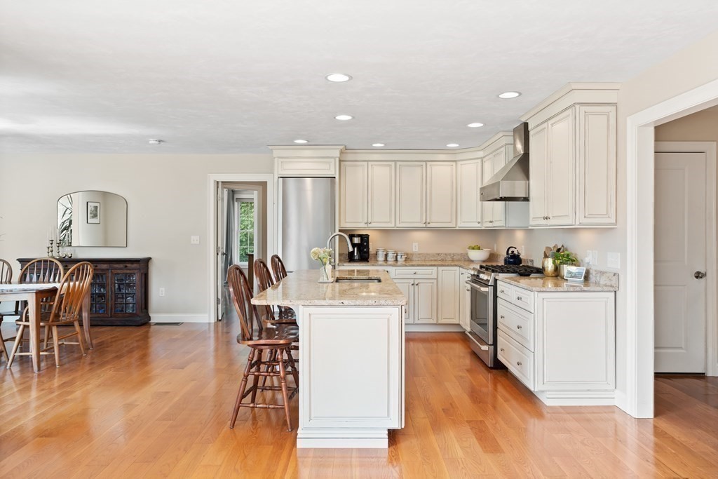 145 Old Farm Way Ayer, MA 01432 - Photo 16 of 39 a kitchen with a sink a stove cabinets and wooden floor