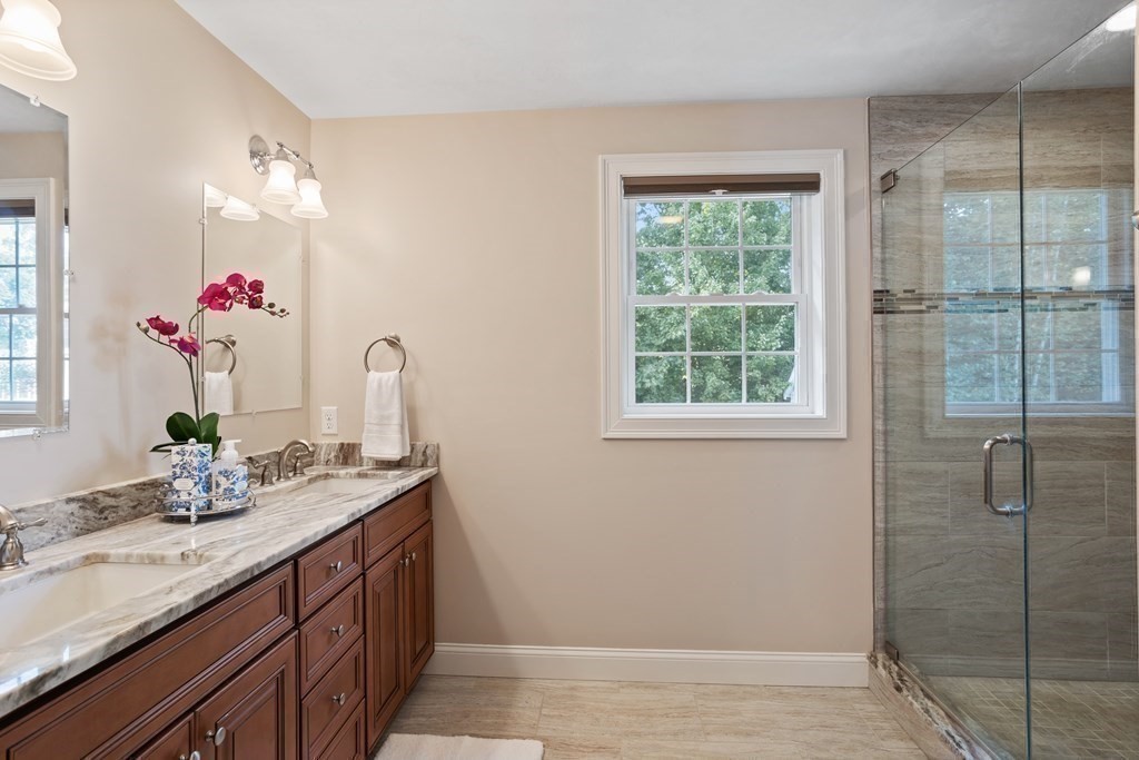 145 Old Farm Way Ayer, MA 01432 - Photo 23 of 39 a bathroom with a granite countertop sink a shower and a mirror