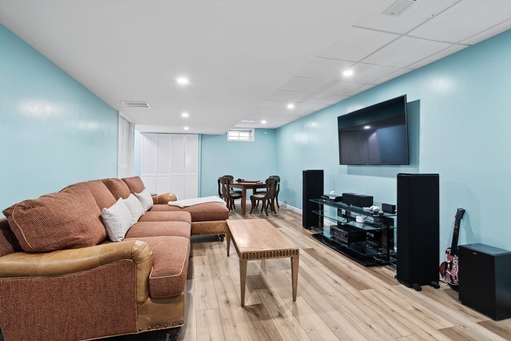 145 Old Farm Way Ayer, MA 01432 - Photo 28 of 39 a living room with furniture a flat screen tv and a fireplace