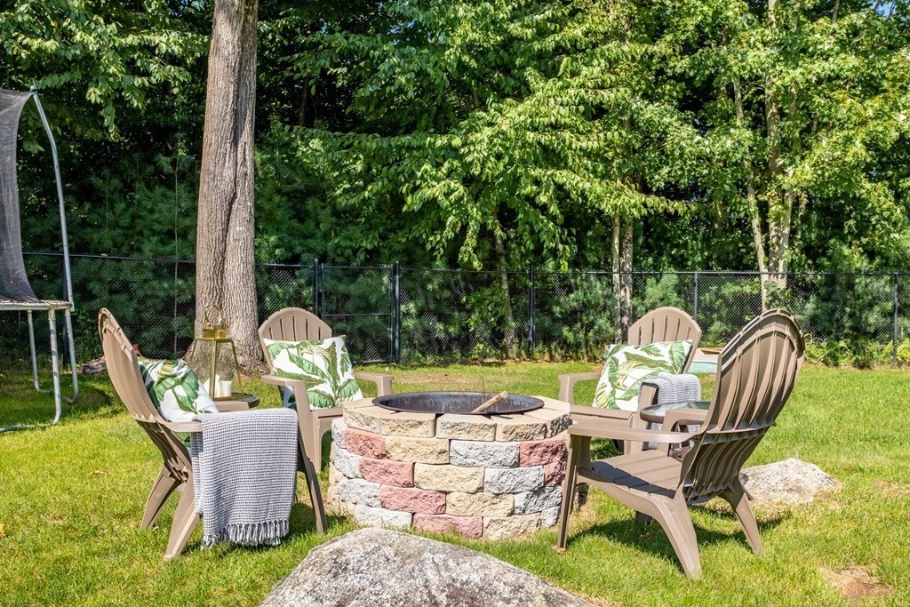145 Old Farm Way Ayer, MA 01432 - Photo 30 of 39 a view of a chair and table in backyard