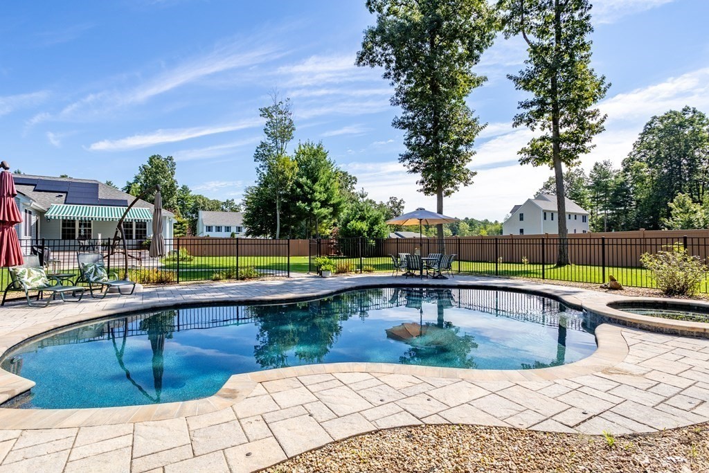 145 Old Farm Way Ayer, MA 01432 - Photo 31 of 39 a view of a swimming pool with a lounge chair