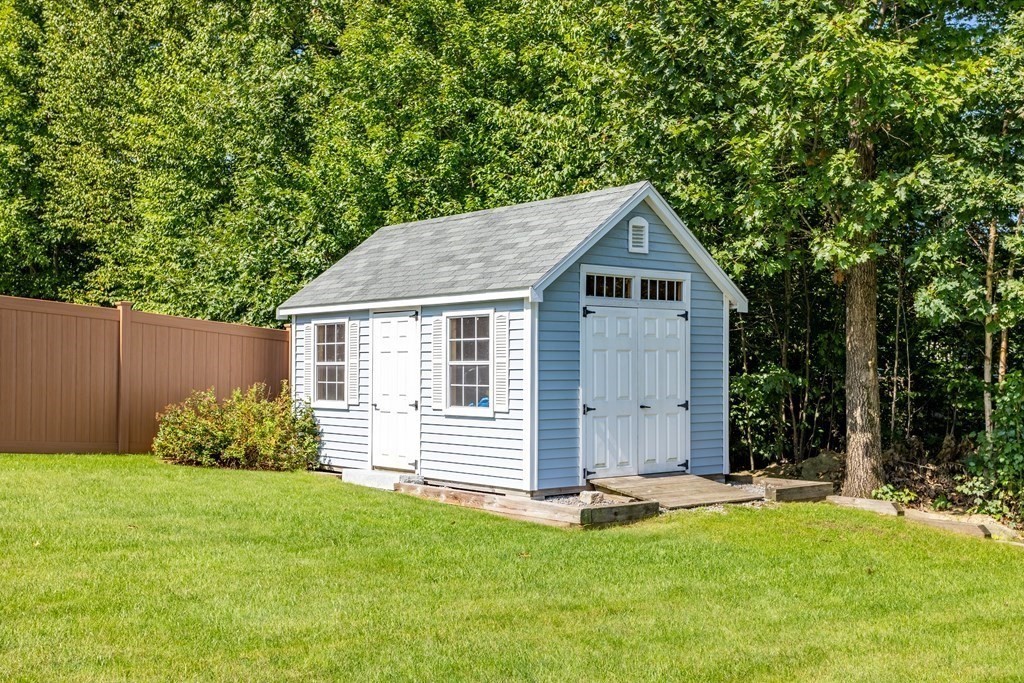 145 Old Farm Way Ayer, MA 01432 - Photo 32 of 39 a front view of a house with a yard and garage