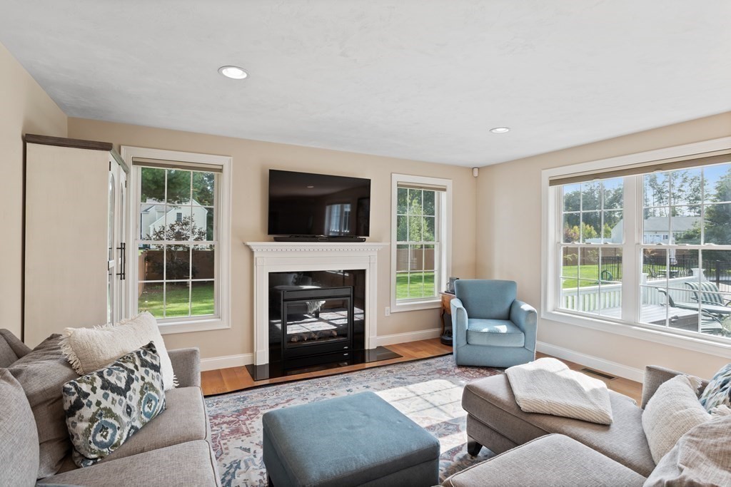 145 Old Farm Way Ayer, MA 01432 - Photo 10 of 39 a living room with furniture and a fireplace