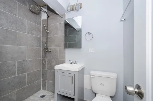 a bathroom with a toilet sink and shower