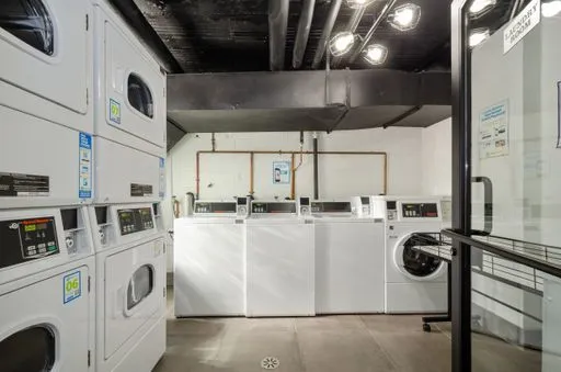 a view of a kitchen with a sink washer and dryer