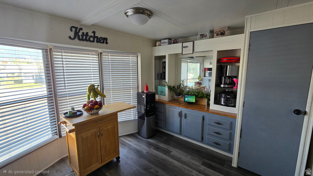 1500 Angel Street North, Unit 53 Layton, UT 84041 - Photo 6 of 20 Kitchen area featuring wood-finish flooring, multiple windows with blinds, a built-in cabinetry unit with wood-finish countertops and blue cabinet doors, and recessed shelving
