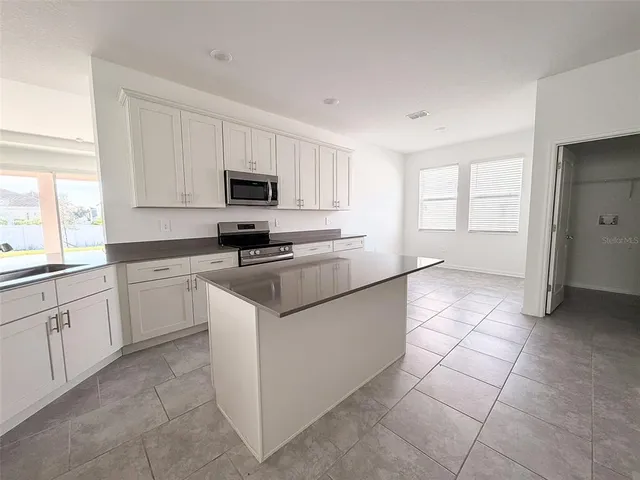 a kitchen with cabinets and window