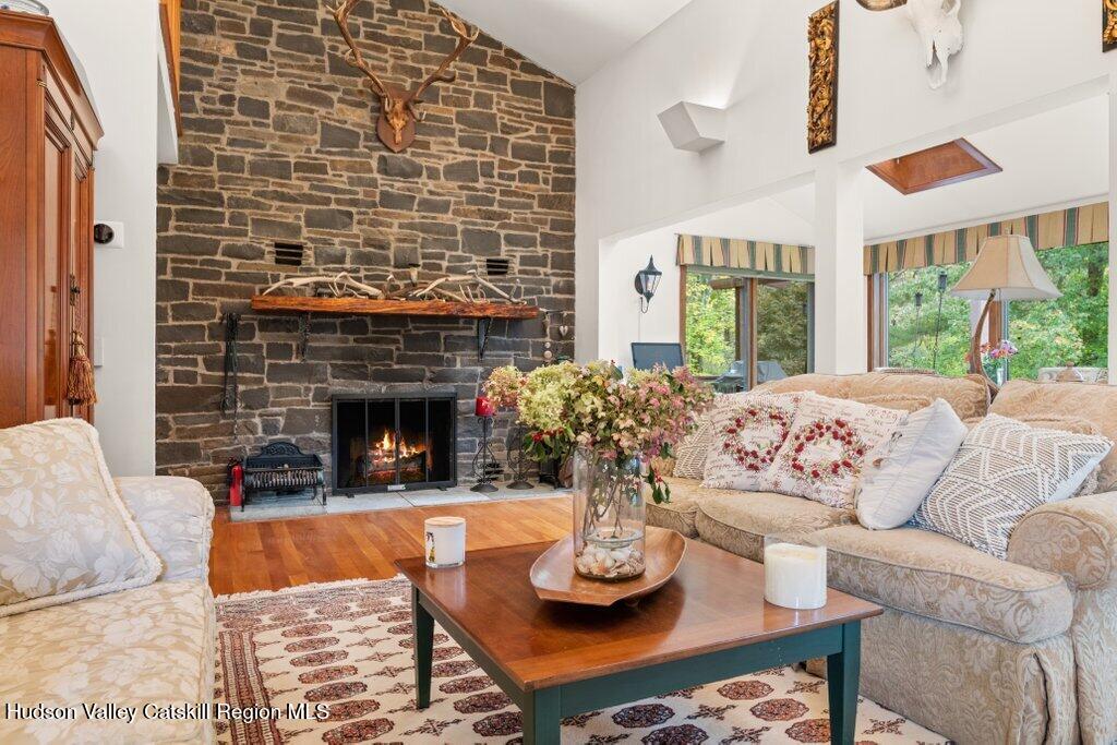 388 Sky Farm Road, Unit STOP 11 Copake, NY 12516 - Photo 17 of 57 a living room with furniture and a fireplace