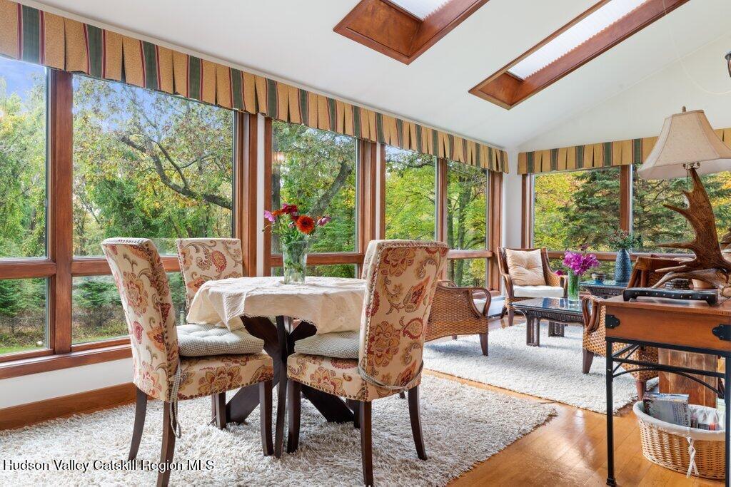 388 Sky Farm Road, Unit STOP 11 Copake, NY 12516 - Photo 21 of 57 a view of a dining room with furniture large windows and wooden floor
