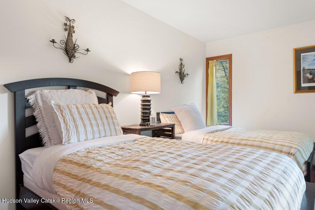 388 Sky Farm Road, Unit STOP 11 Copake, NY 12516 - Photo 32 of 57 a bedroom with a bed and a window