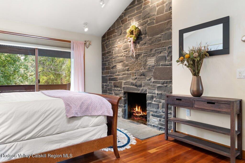 388 Sky Farm Road, Unit STOP 11 Copake, NY 12516 - Photo 41 of 57 a bedroom with a bed and a fireplace