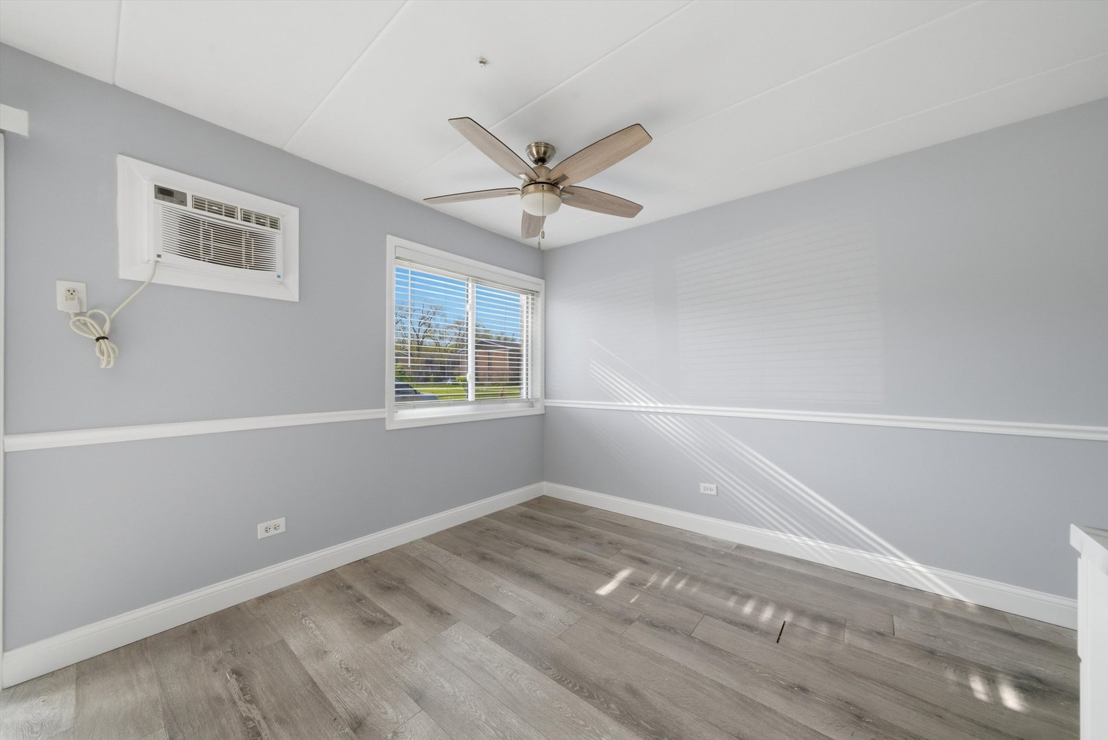 18205 Hart Drive, Unit 3A Homewood, IL 60430 - Photo 18 of 27 wooden floor in an empty room with a window