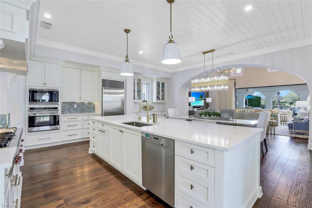 16683 Lucarno Way Naples, FL 34110 - Photo 11 of 35 a large kitchen with stainless steel appliances a large center island attached withe living room