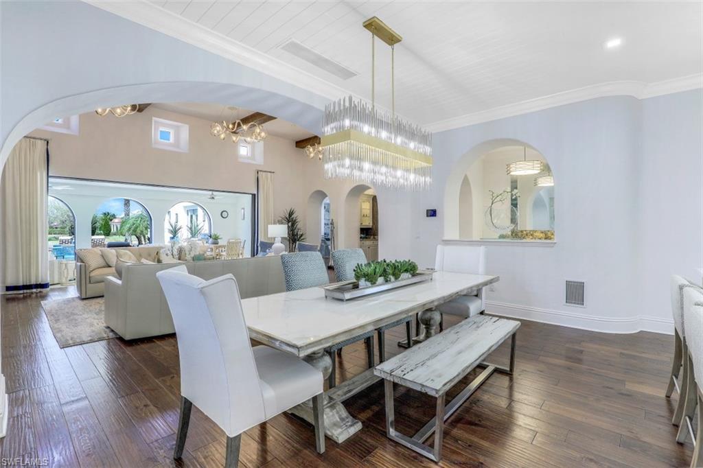 16683 Lucarno Way Naples, FL 34110 - Photo 12 of 35 a view of a dining room with furniture and wooden floor