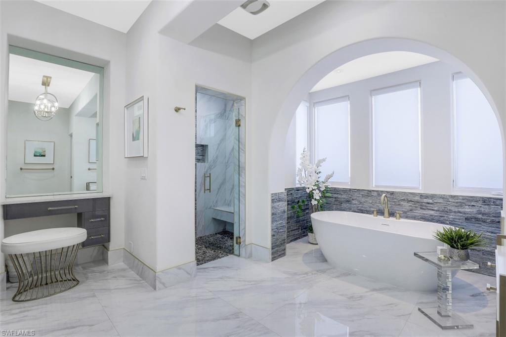 16683 Lucarno Way Naples, FL 34110 - Photo 17 of 35 a spacious bathroom with a bathtub sink and toilet