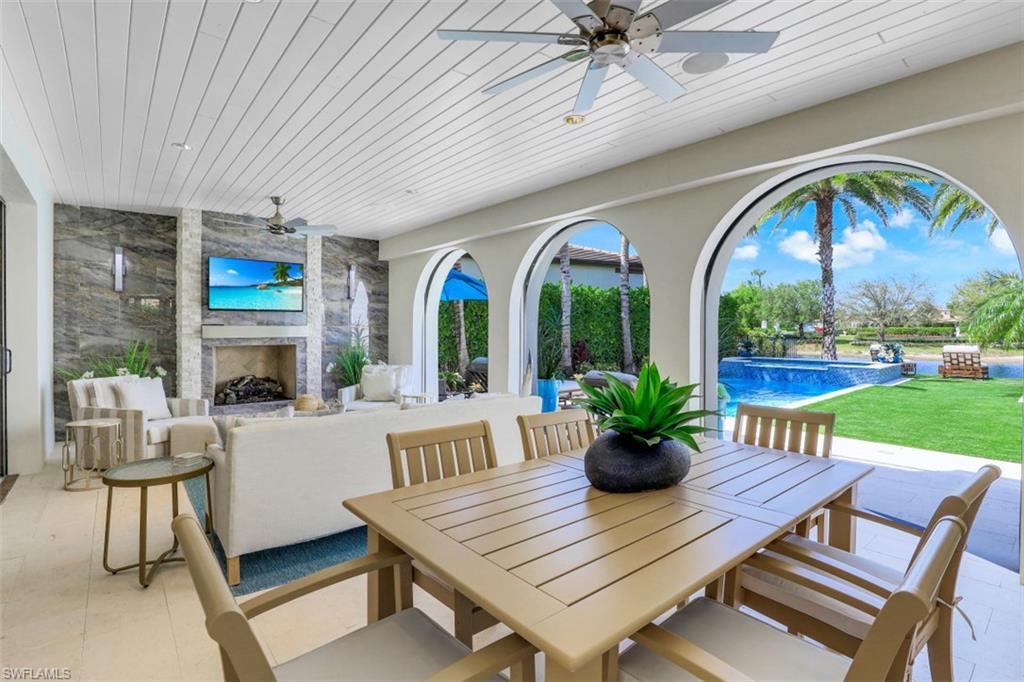 16683 Lucarno Way Naples, FL 34110 - Photo 2 of 35 a view of a dining room with furniture wooden floor and a floor to ceiling window