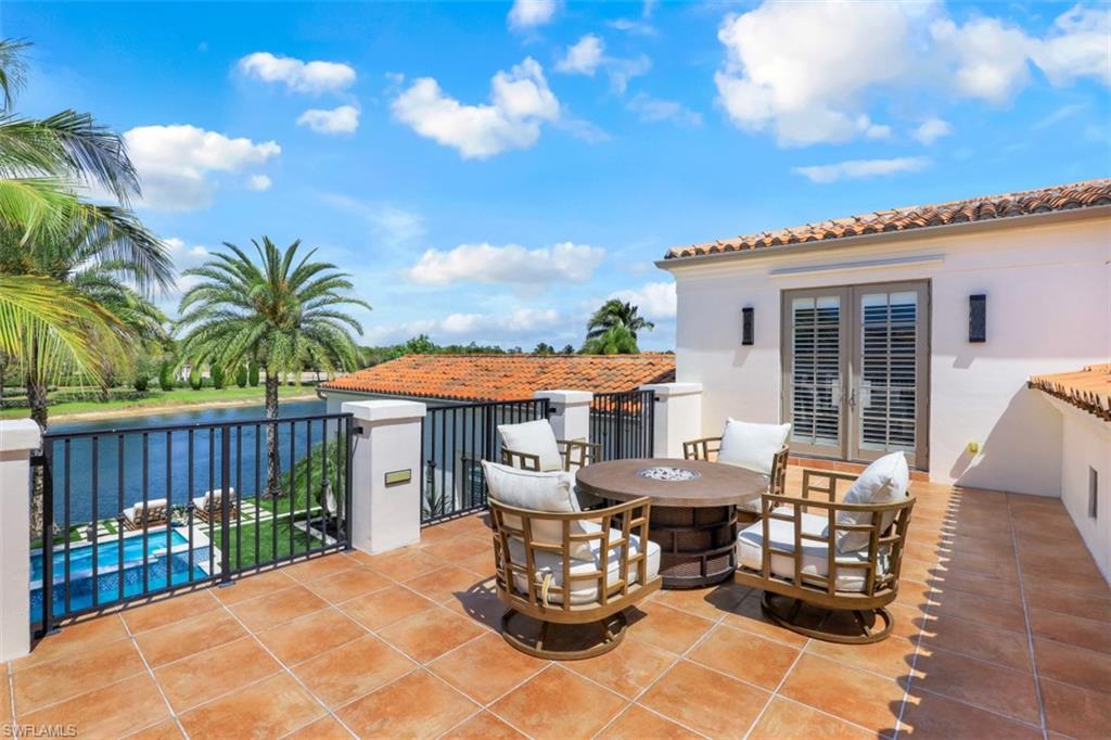 16683 Lucarno Way Naples, FL 34110 - Photo 21 of 35 a view of a table and chairs in patio