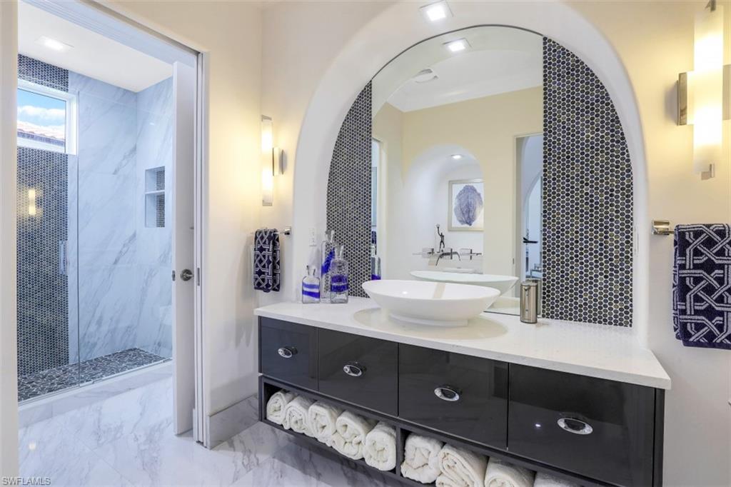 16683 Lucarno Way Naples, FL 34110 - Photo 27 of 35 a en suite bathroom with a double vanity sink and a mirror