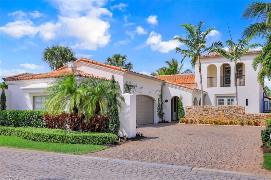 16683 Lucarno Way Naples, FL 34110 - Photo 28 of 35 a front view of a house with a yard and garage