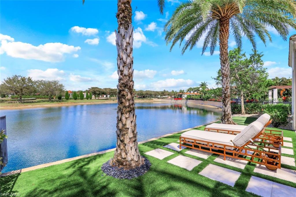 16683 Lucarno Way Naples, FL 34110 - Photo 4 of 35 a view of a lake with a table and chairs