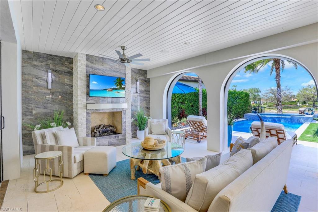 16683 Lucarno Way Naples, FL 34110 - Photo 6 of 35 a living room with fireplace furniture and a large window