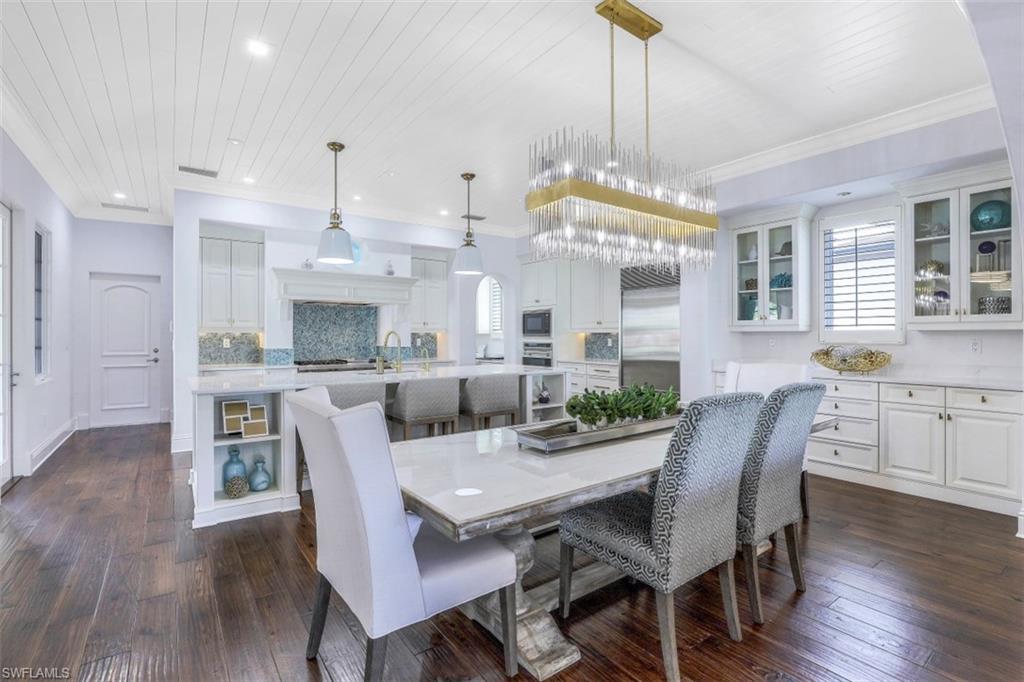16683 Lucarno Way Naples, FL 34110 - Photo 9 of 35 a view of a dining room with furniture window and wooden floor